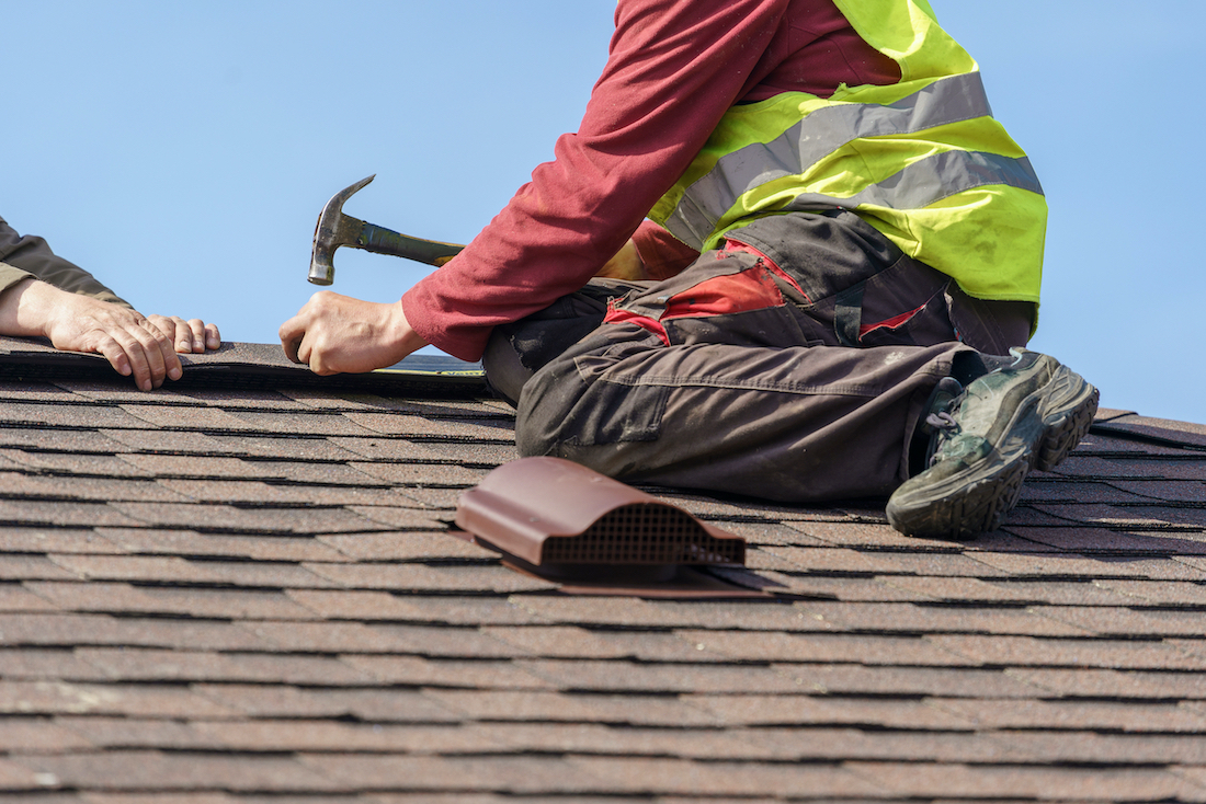 Roof worker working on roof repairs