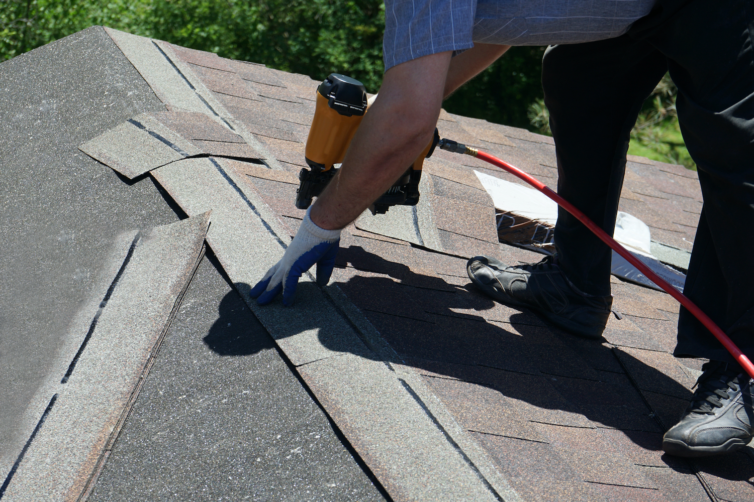 Roofing Contractor replacing shingles in a Spring, TX roof replacement