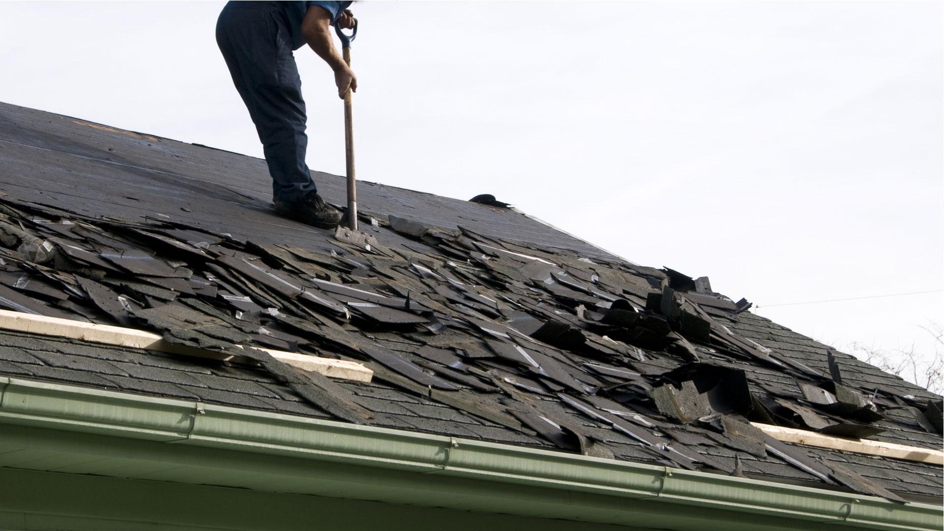 Houston roofing company removing old shingles for Sienna Plantation roof replacement