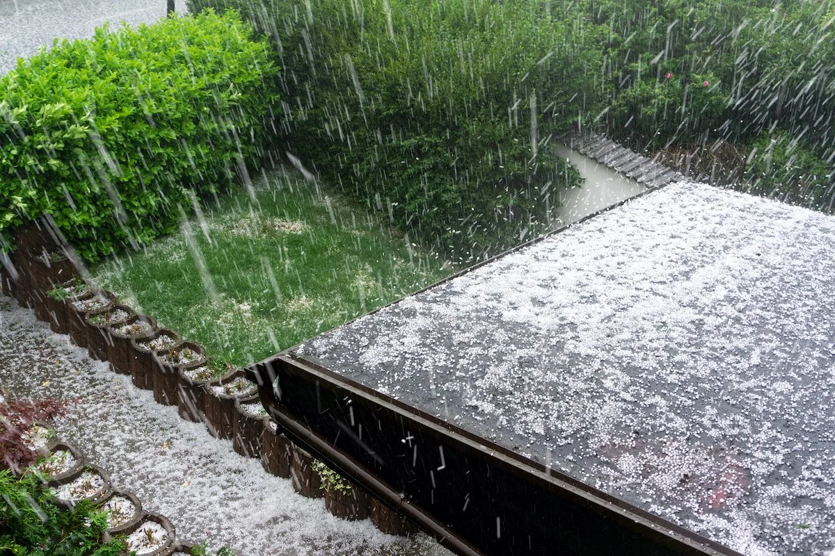 Hail storm taking place in Houston, causing hail roof damage to Cypress roofing
