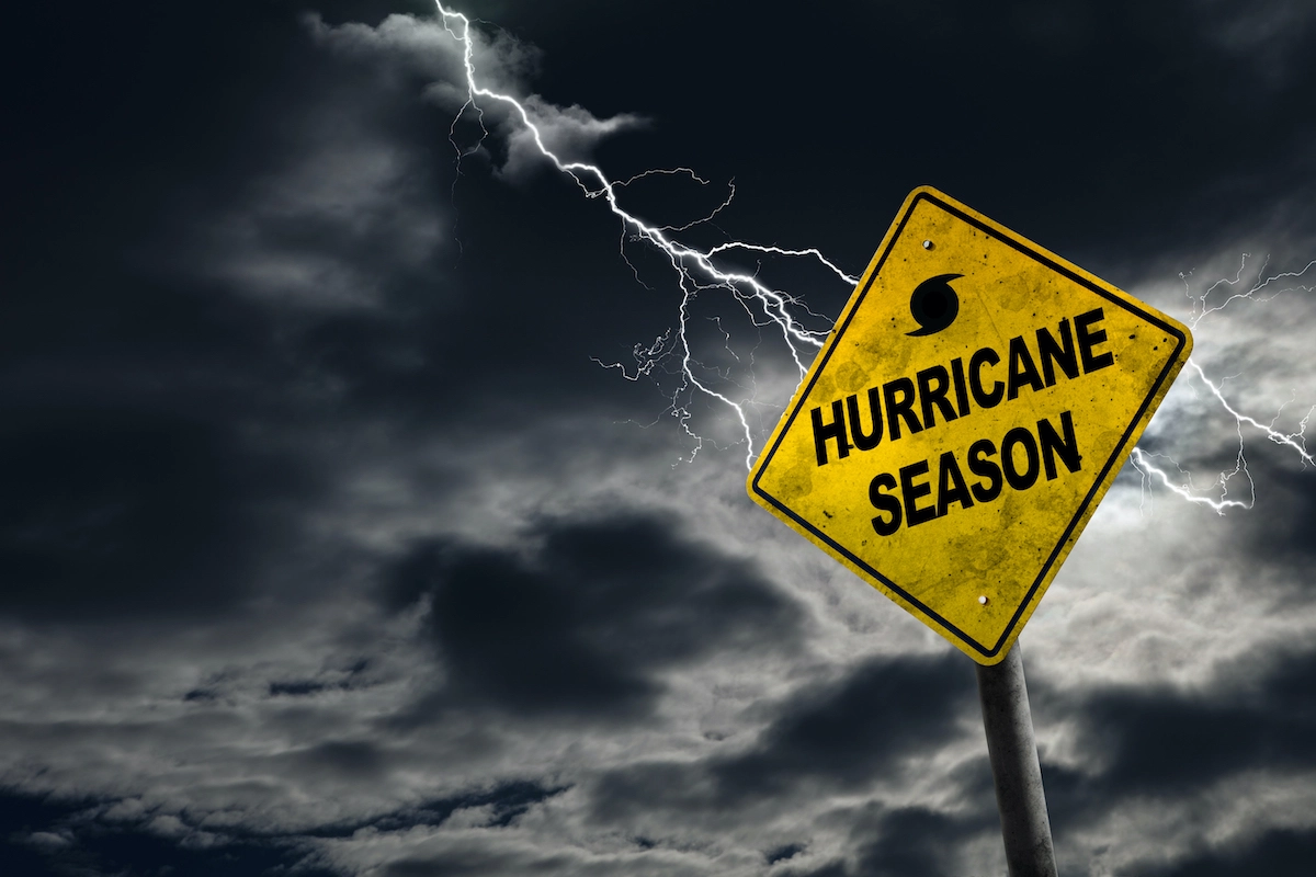 Sign that says "hurricane season" on it with a storm taking place in the background, signifying the severity of Cypress roof damage
