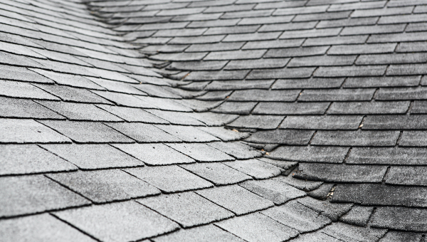 Brittle damaged roof shingles during the winter, which require Tomball roof repairs
