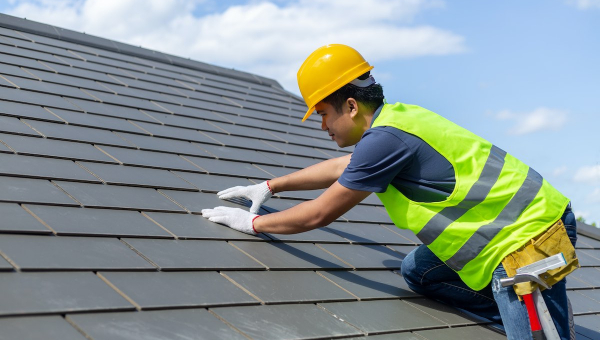 Houston roofer installing slate roof tiles