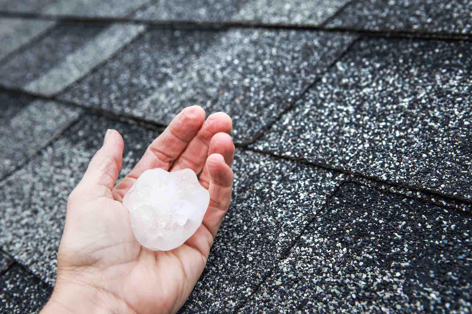 Homeowner holds hail stone that caused Houston roof damage