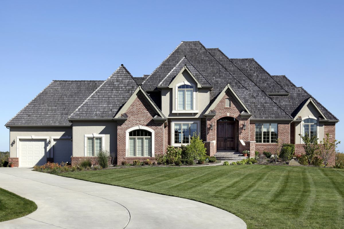 Large luxury home featuring a Hedwig Village roof replacement with DaVinci shake roofing