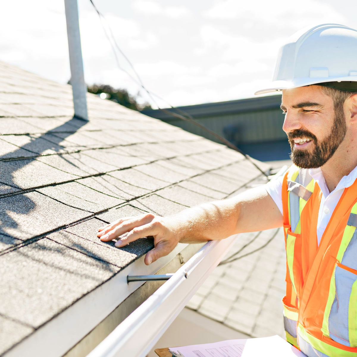 A roofer inspecting a roof