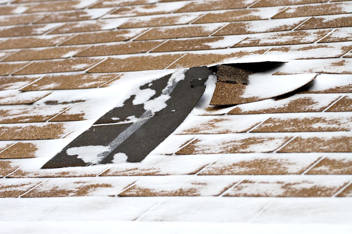 Katy roofing that has sustained cold weather roof damage in the form of damaged shingles.