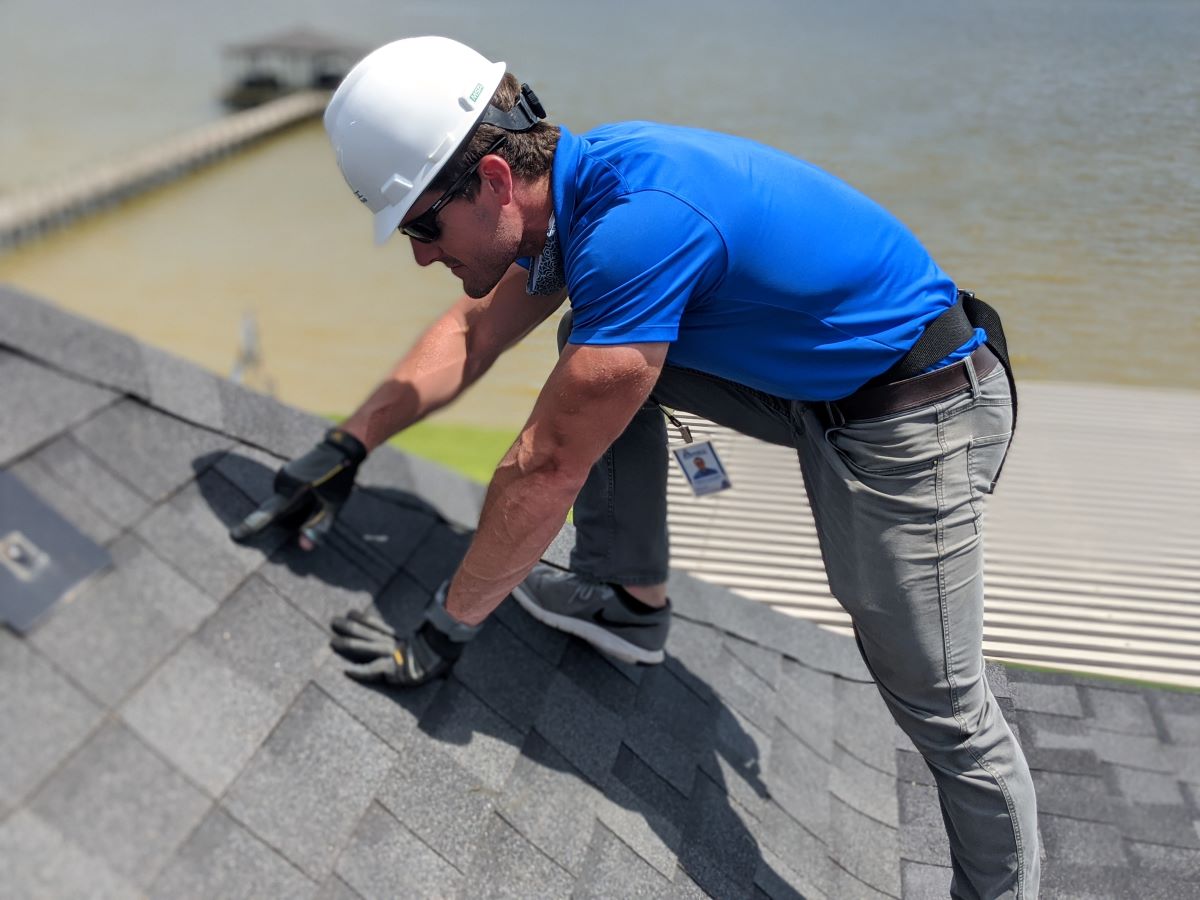 Our Houston roofer inspects Houston storm damage on Houston roof.