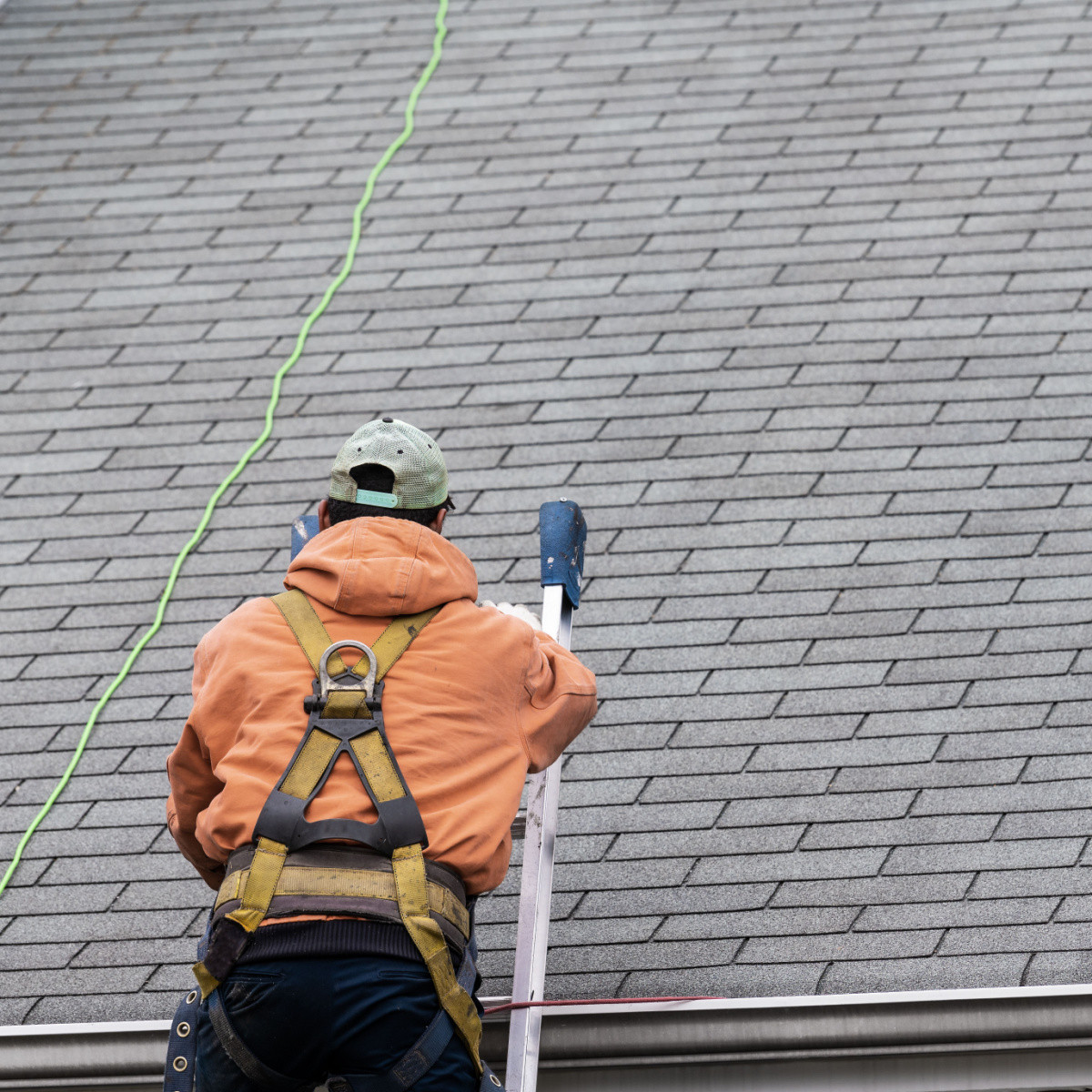 A Houston roofer double checks a finished roof replacement job.