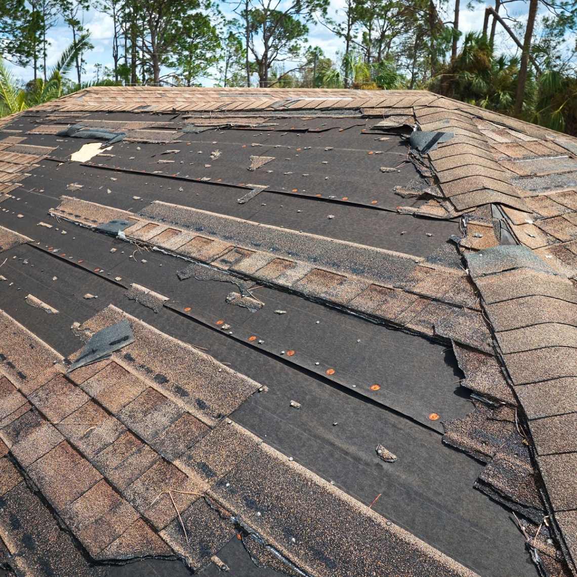 Rosenberg roof with clear signs of wind roof damage.