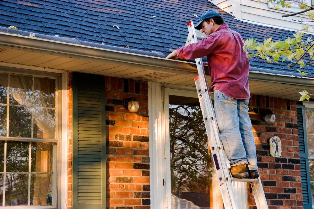Homeowner completeing Houston roof maintenance