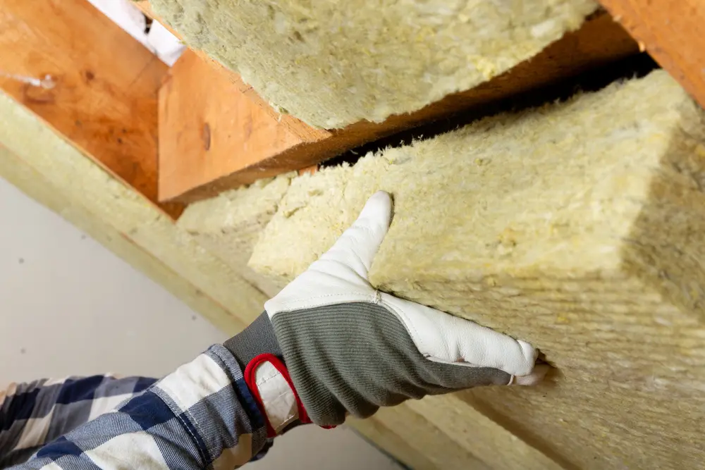 Attic insulation being installed to prevent Tomball roof damage