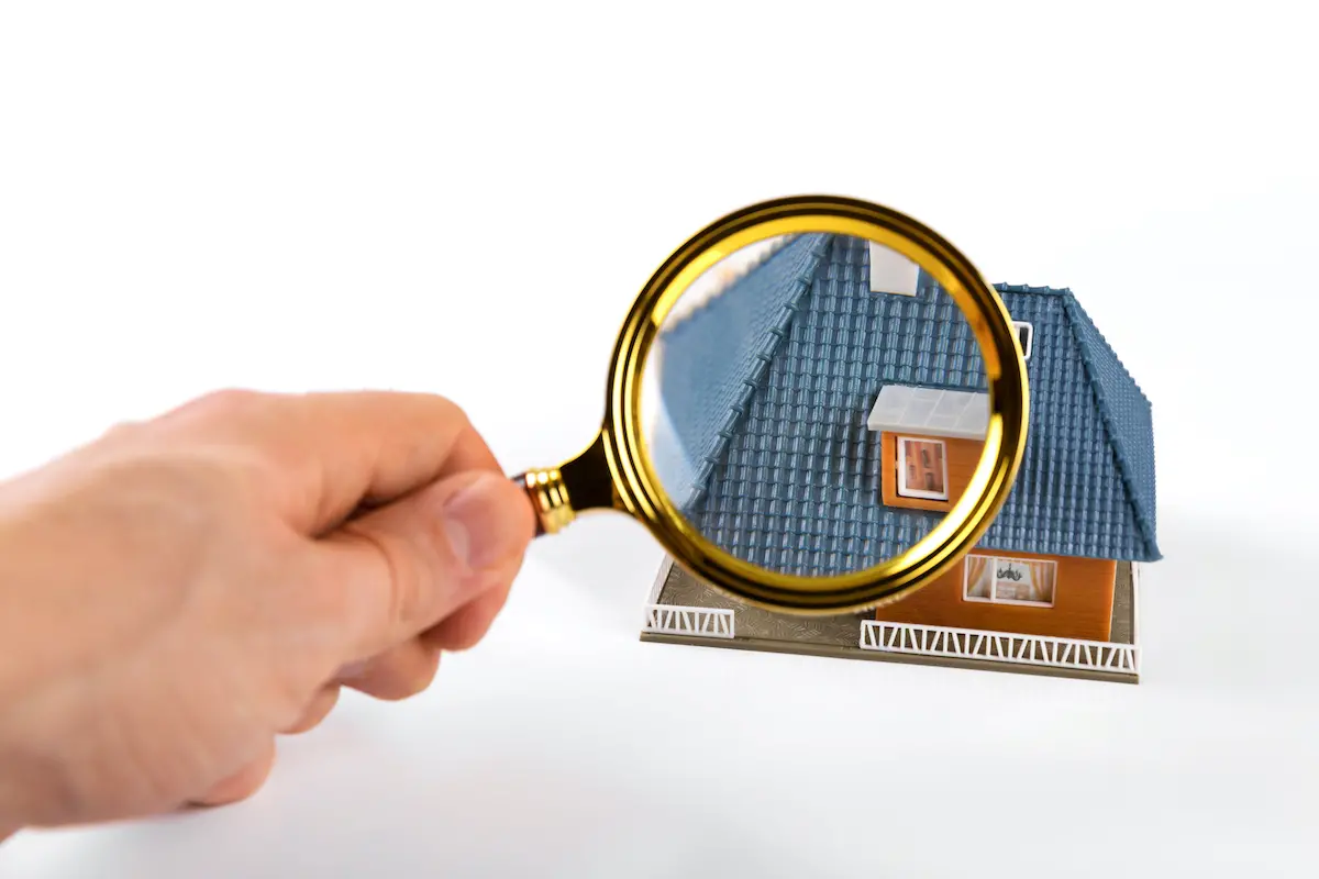 Magnifying glass held over roof to signify seasonal Piney Point Village roof inspection