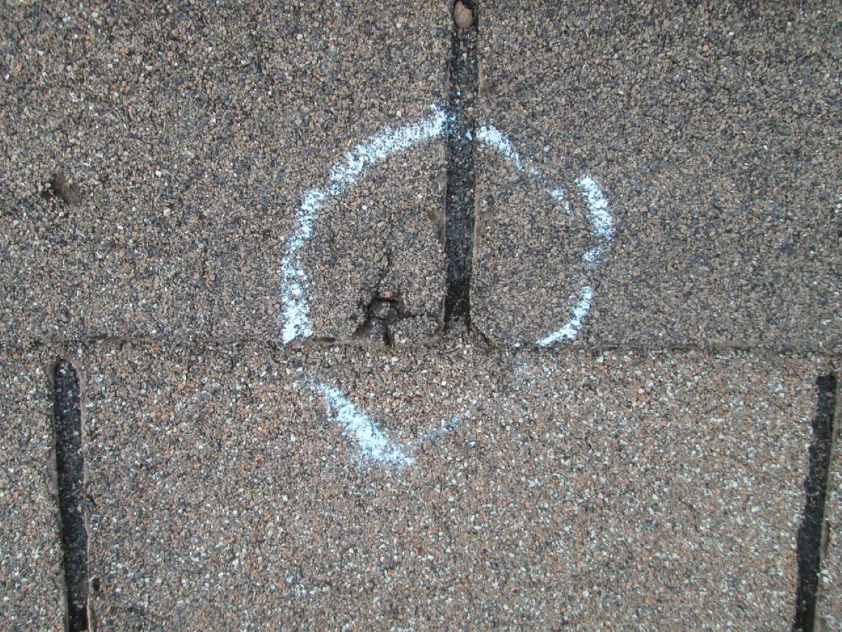 Chalk circle outlining Kingwood hail roof damage